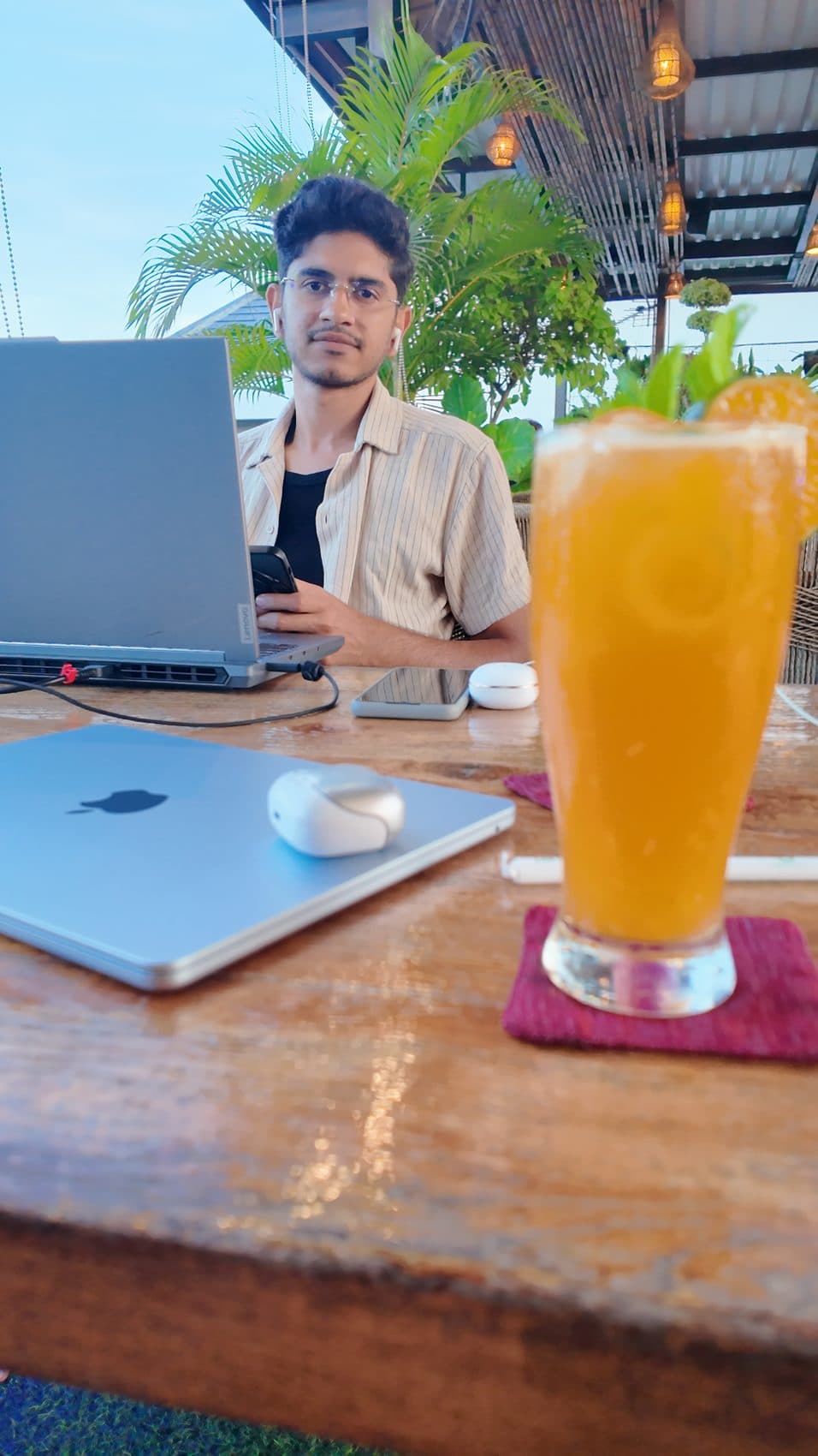 Rooftop laptop session with fresh orange juice in the foreground