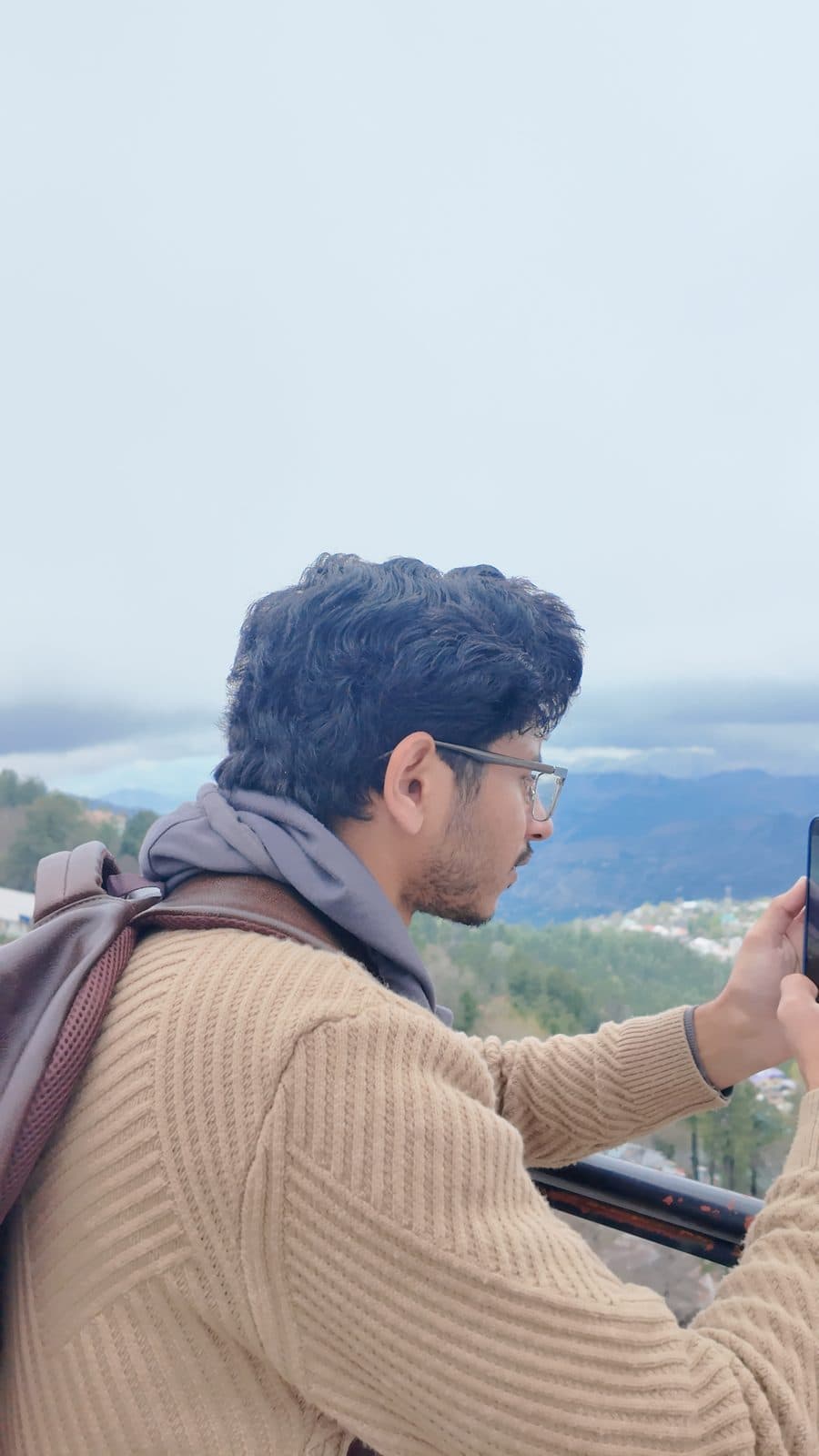 Photographing a valley view, knit sweater