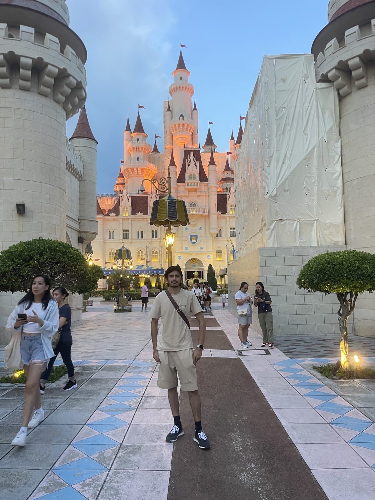 Standing in a castle plaza at dusk
